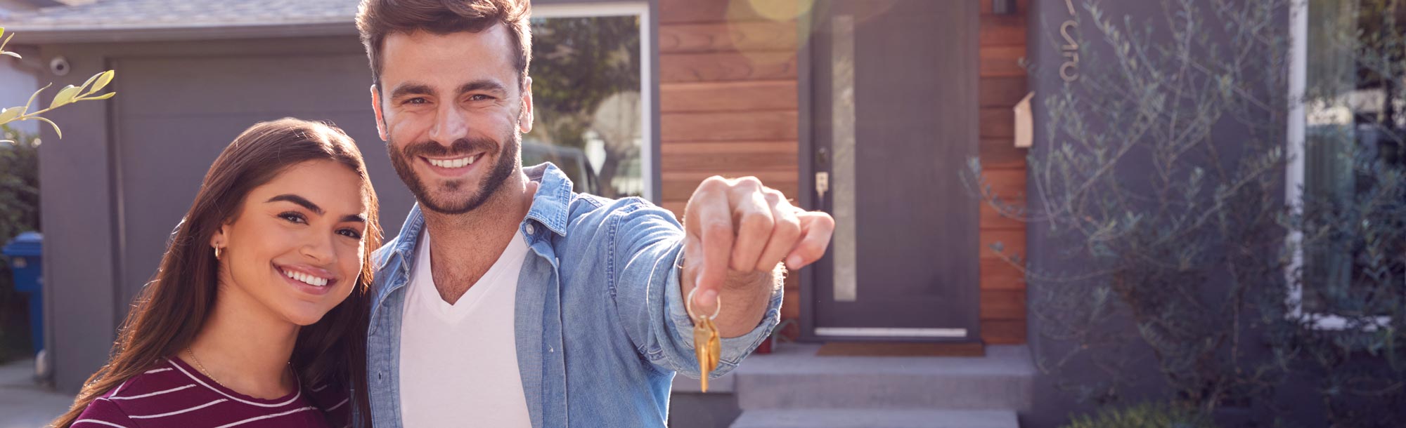 Happy Couple Holding Up New House Keys